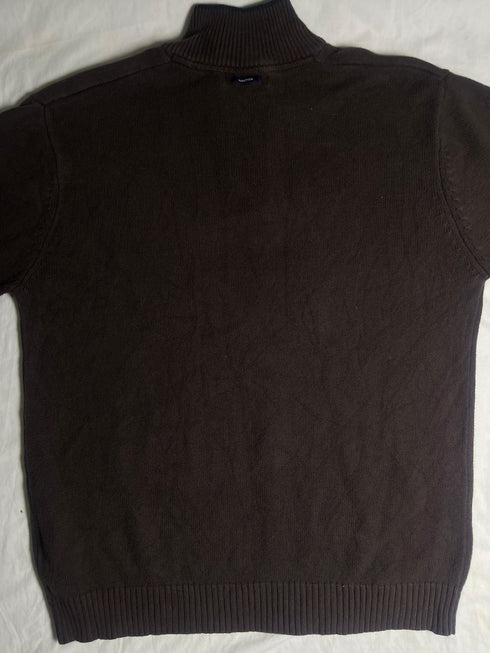 Close-up view of inner neck tag on vintage Nautica brown quarter-zip jumper showing size Large, 100 percent cotton label, and Made in Thailand tag
