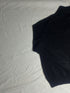 Close-up of vintage Nautica black quarter-zip sweater collar showing grey ribbed lining, size XL tag, silver zipper pull, and embroidered sail chest logo